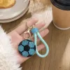 A blue diamond-encrusted football-shaped keychain with a light green braided rope handle details Picture